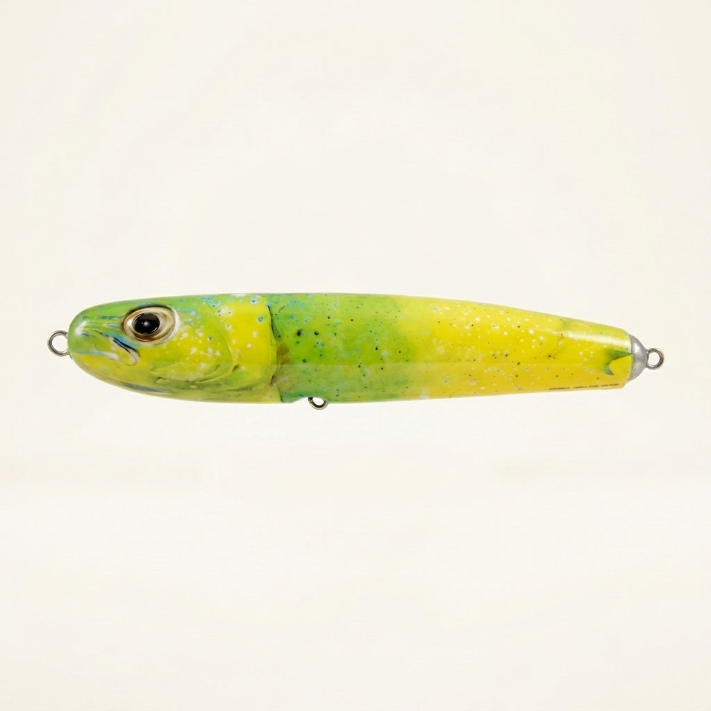 Mahi mahi pattern JigSkinz lure skin on a saltwater stickbait, side view on dark background