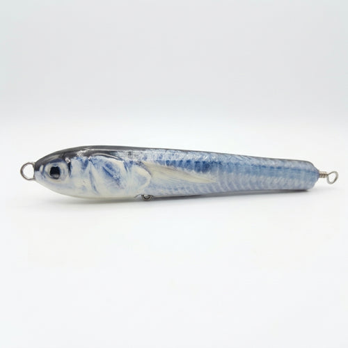Ballyhoo pattern JigSkinz lure skin on a saltwater pencil popper, side view on dark background