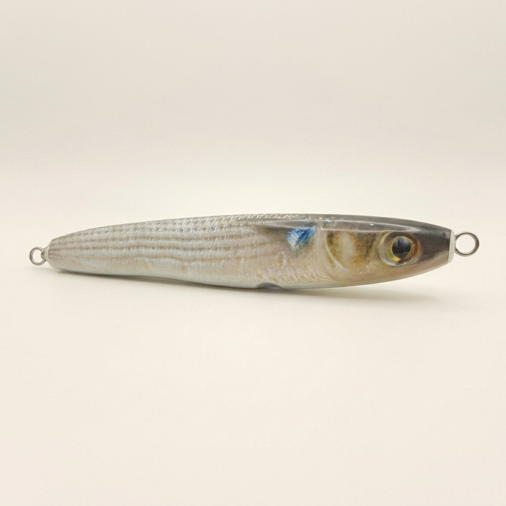 Mullet pattern JigSkinz lure skin on a saltwater stickbait, side view on dark background