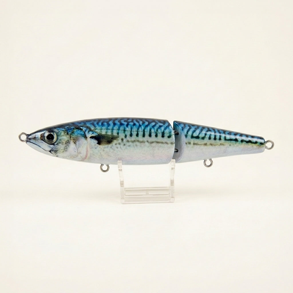 Mackerel pattern JigSkinz lure skin on a jointed swimbait, held on wooden table