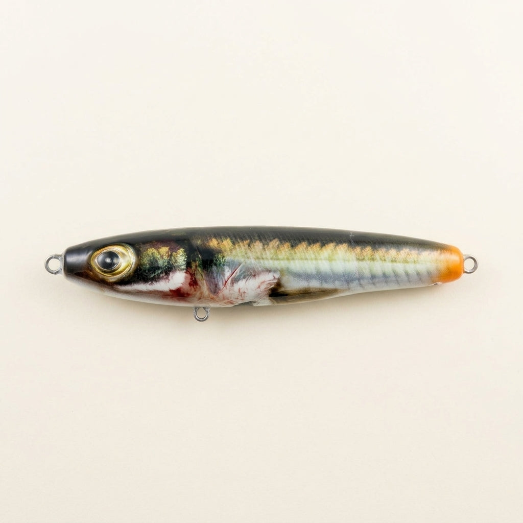 Sand eel pattern JigSkinz lure skins on two saltwater stickbaits, close-up of head and eye