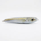 Cigar minnow pattern JigSkinz lure skin on a saltwater stickbait, side view on dark surface