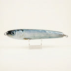 Herring pattern JigSkinz lure skin on a saltwater stickbait, displayed on clear stand against dark background