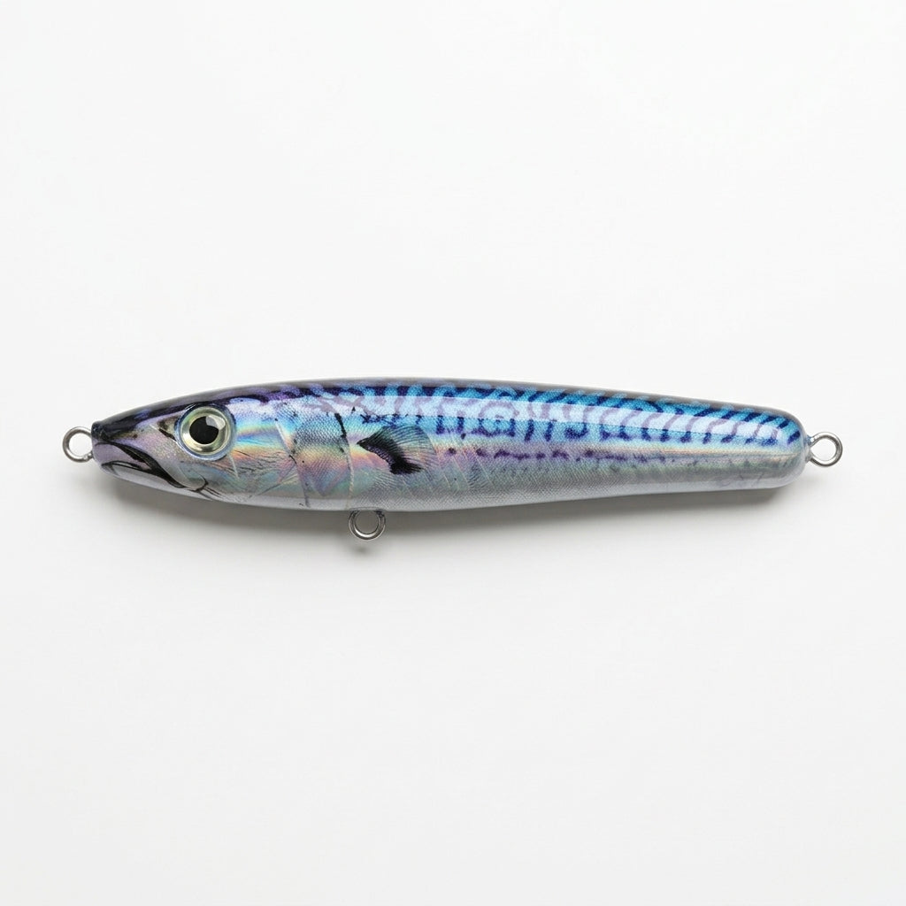 Foil mackerel JigSkinz lure skin on a topwater stickbait, holographic finish, on wooden table