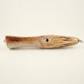 Squid pattern JigSkinz lure skin on a topwater squid popper, side view on dark granite