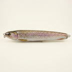 Rainbow trout pattern JigSkinz lure skin on a stickbait, displayed on clear stand against dark background