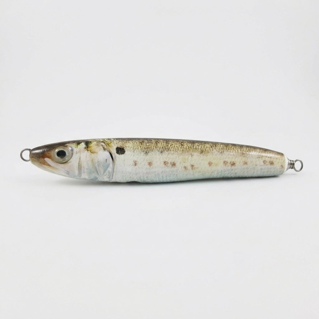 Menhaden bunker pattern JigSkinz lure skin on a saltwater stickbait, side view on dark background