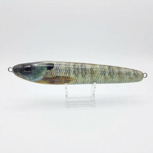 Bluegill pattern JigSkinz lure skin on a stickbait, displayed on clear stand against dark background