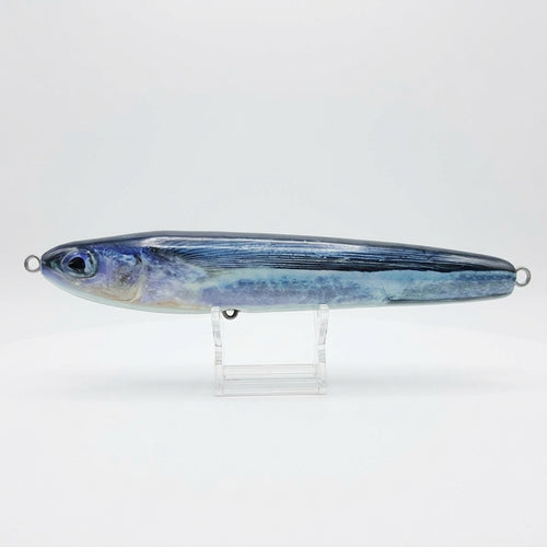 Flying fish pattern JigSkinz lure skin on a saltwater stickbait, on clear stand outdoors